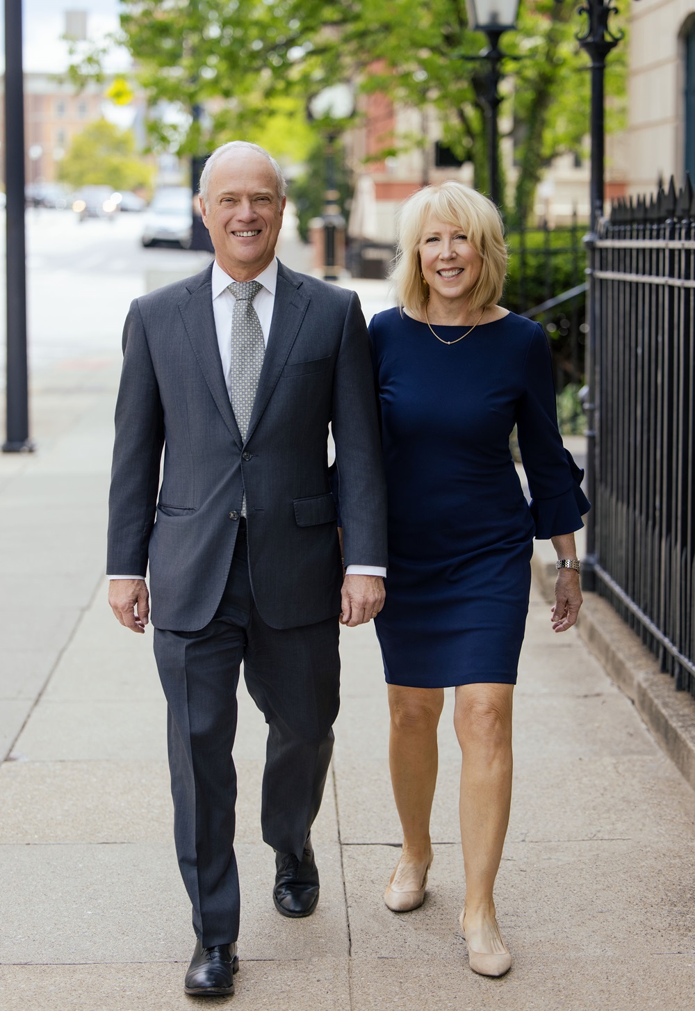 George and Kim Vincent walking down a city street holding hands. George and Kim Vincent walking down a city street holding hands.